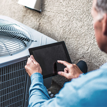 Technician conducting HVAC maintenance in Los Angeles.